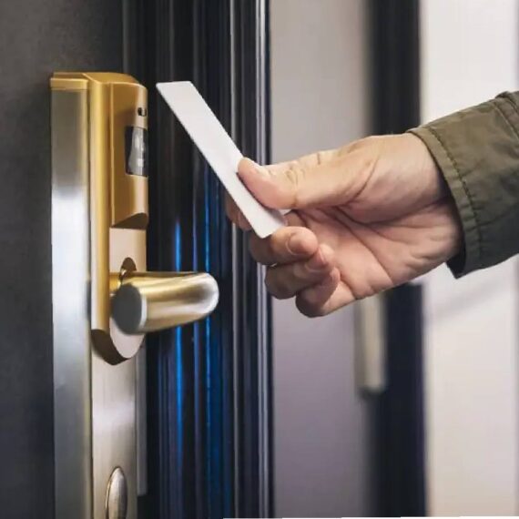 A man is using hotel key card to access the room entry.