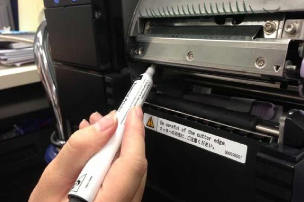 An man is repairing FARGO printer cleaning