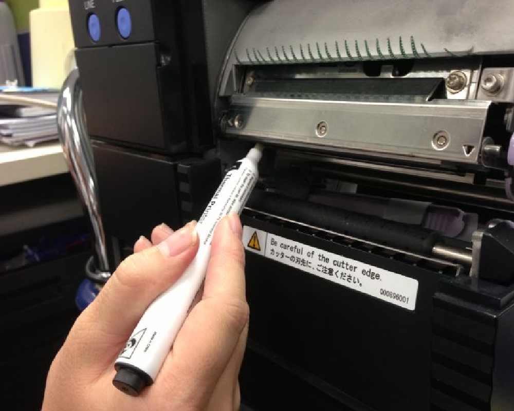 An man is repairing FARGO printer cleaning